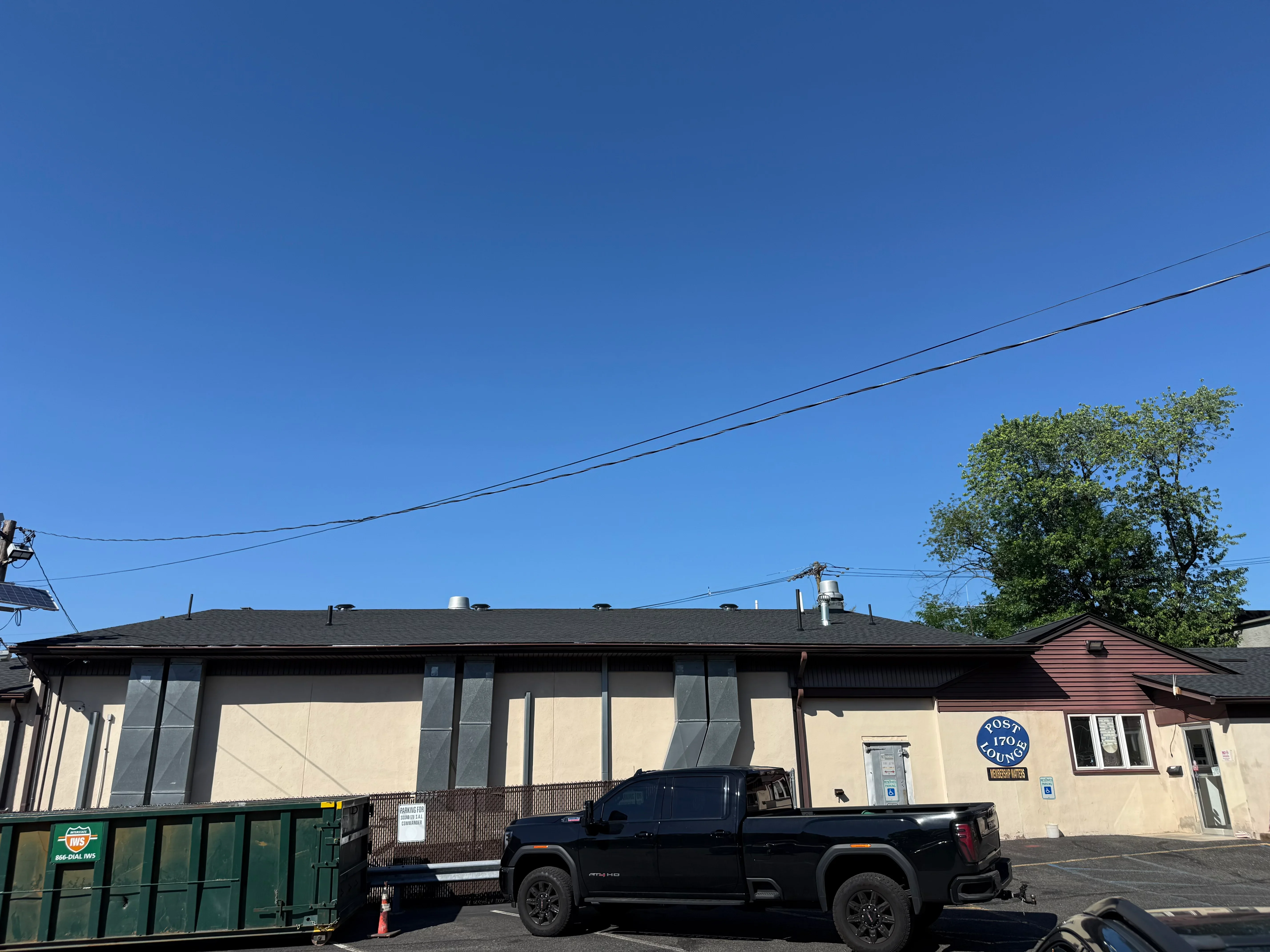 Commercial kitchen building with new windows, dark frames, and cream exterior cladding