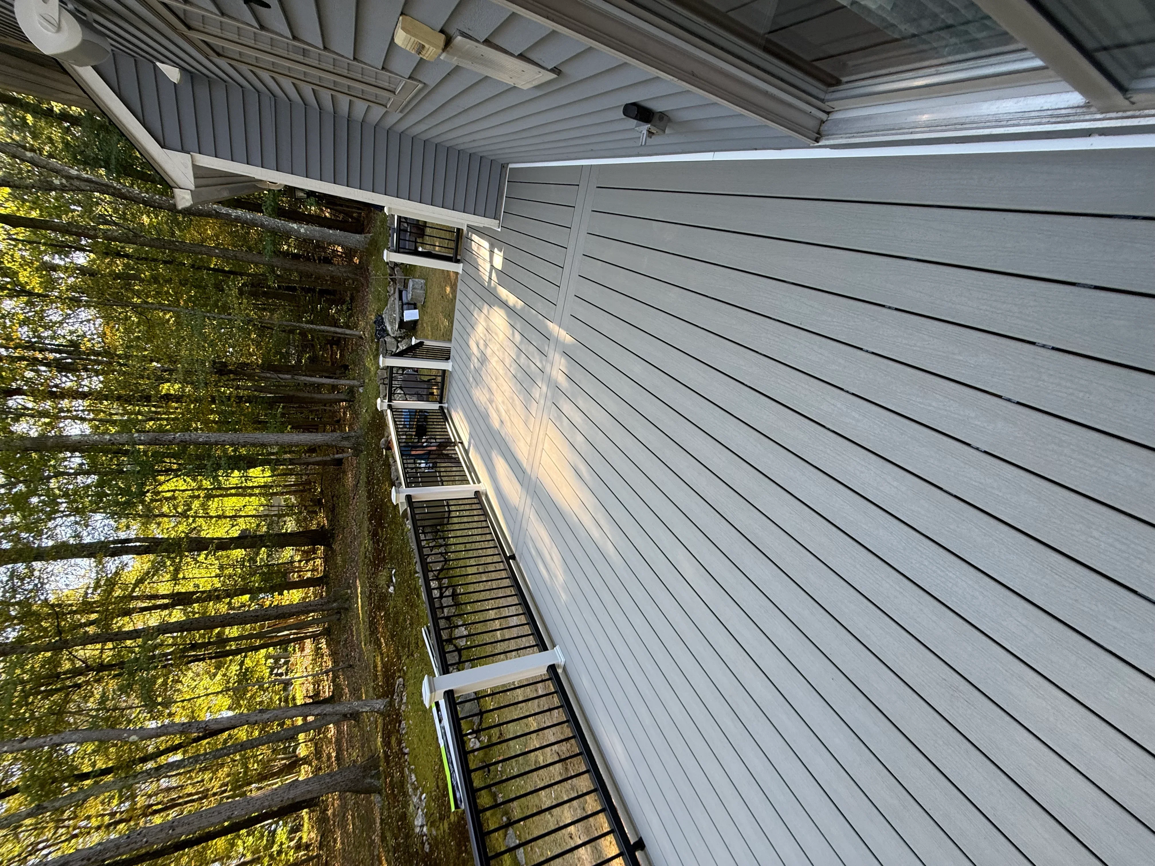 Metal corrugated roof panels installed with white trim and ventilation components
