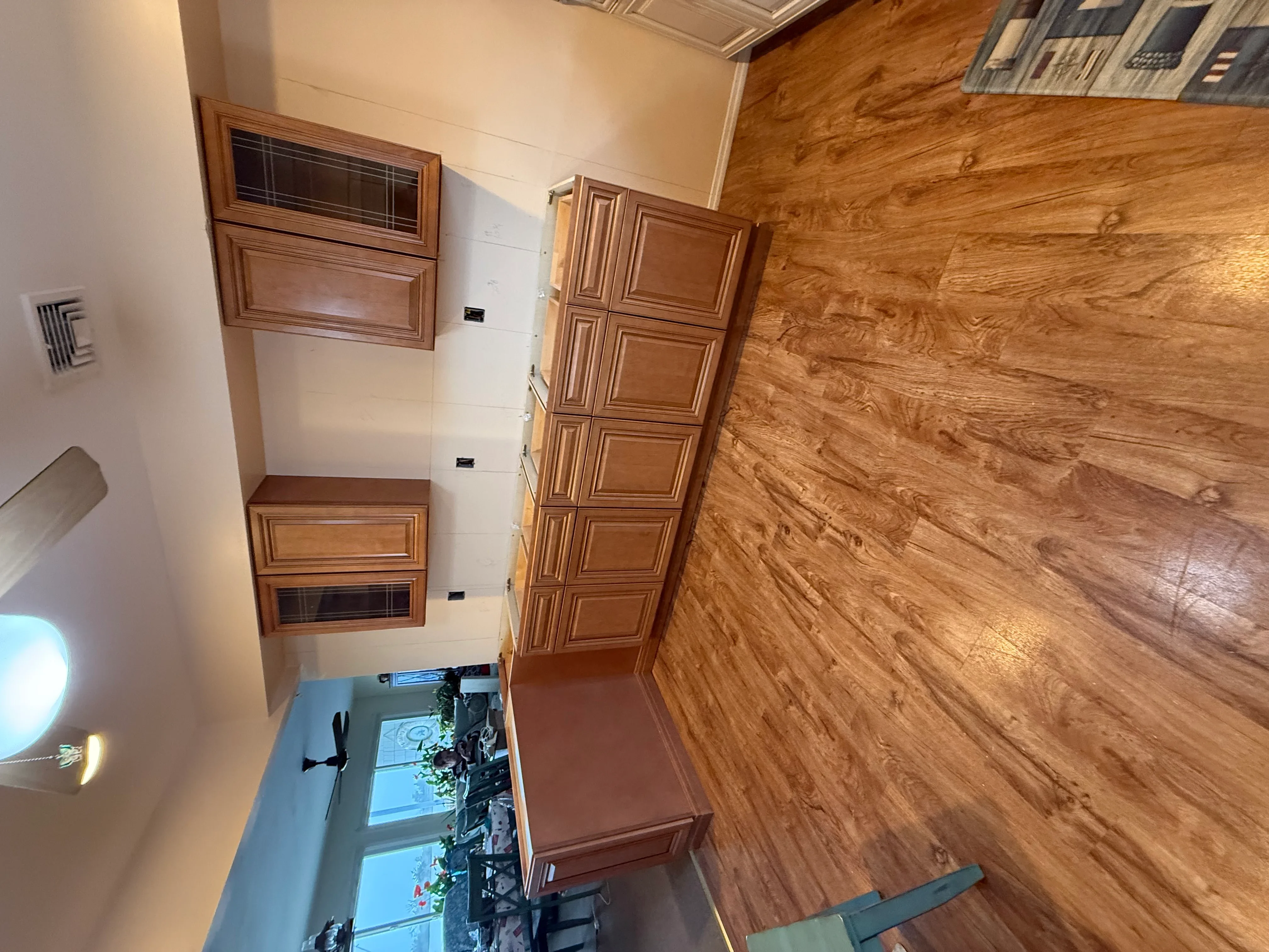 Wood cabinetry with raised panels and hardwood flooring in kitchen renovation