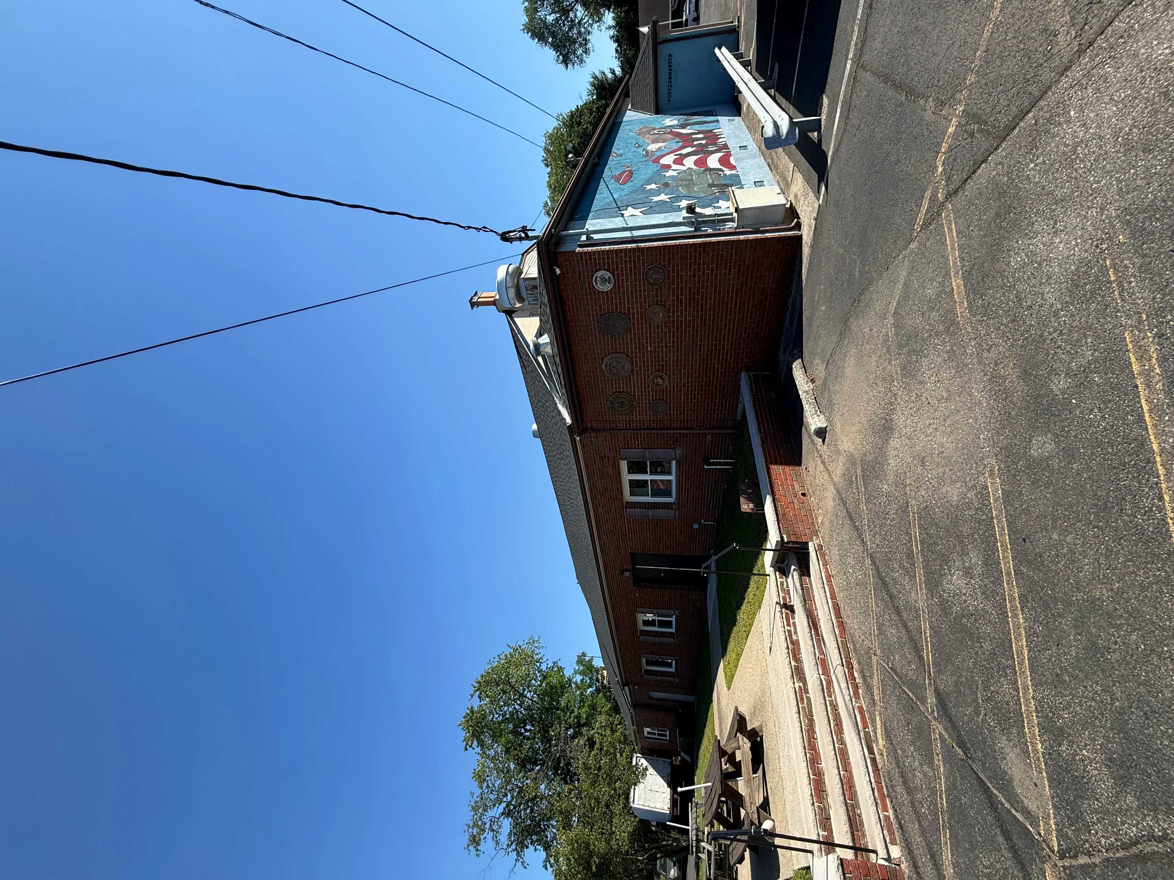 New asphalt shingle roof with patriotic pattern on brick residential home
