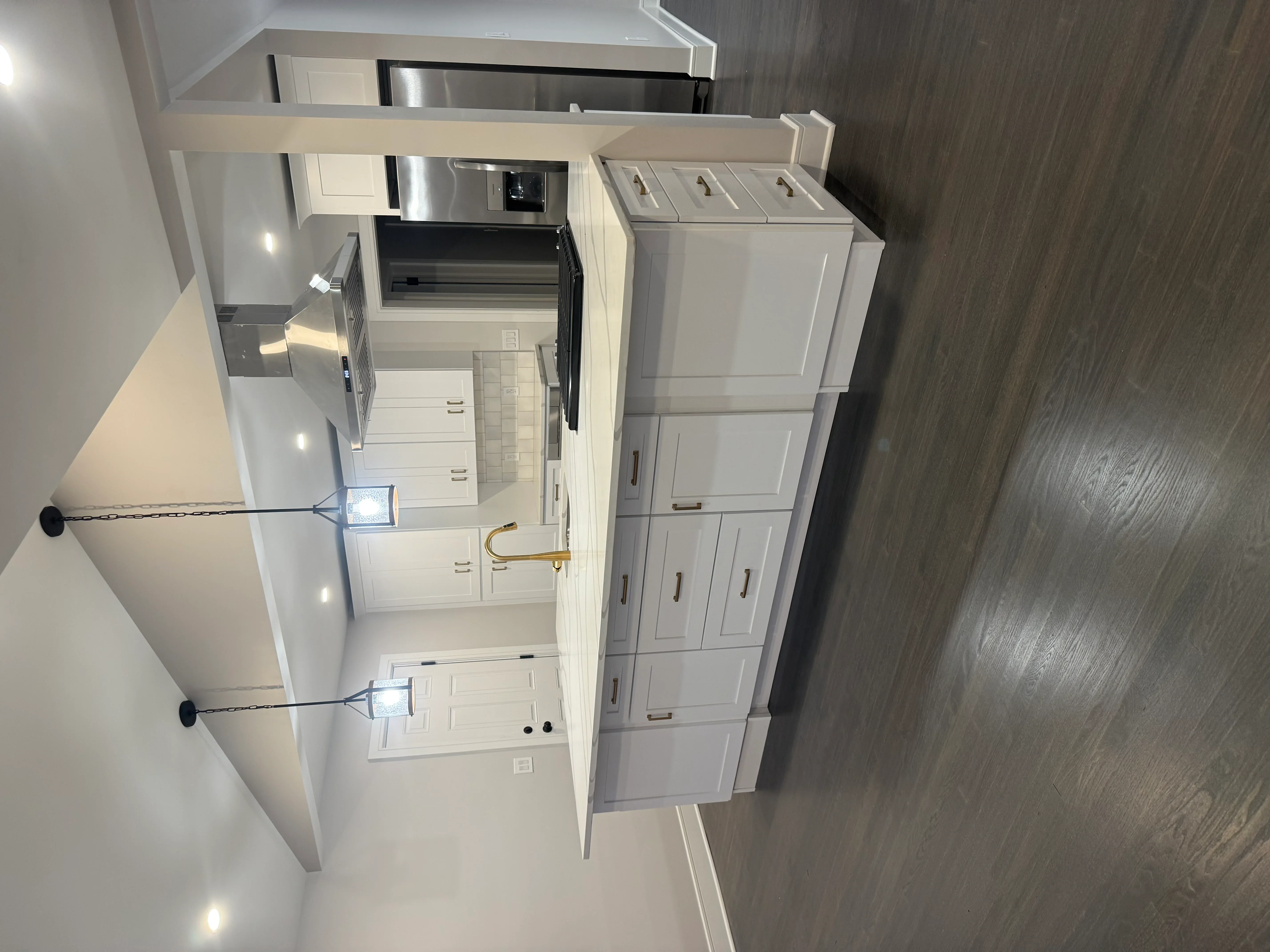 White shaker cabinets, stainless steel appliances, engineered wood flooring, modern kitchen remodel