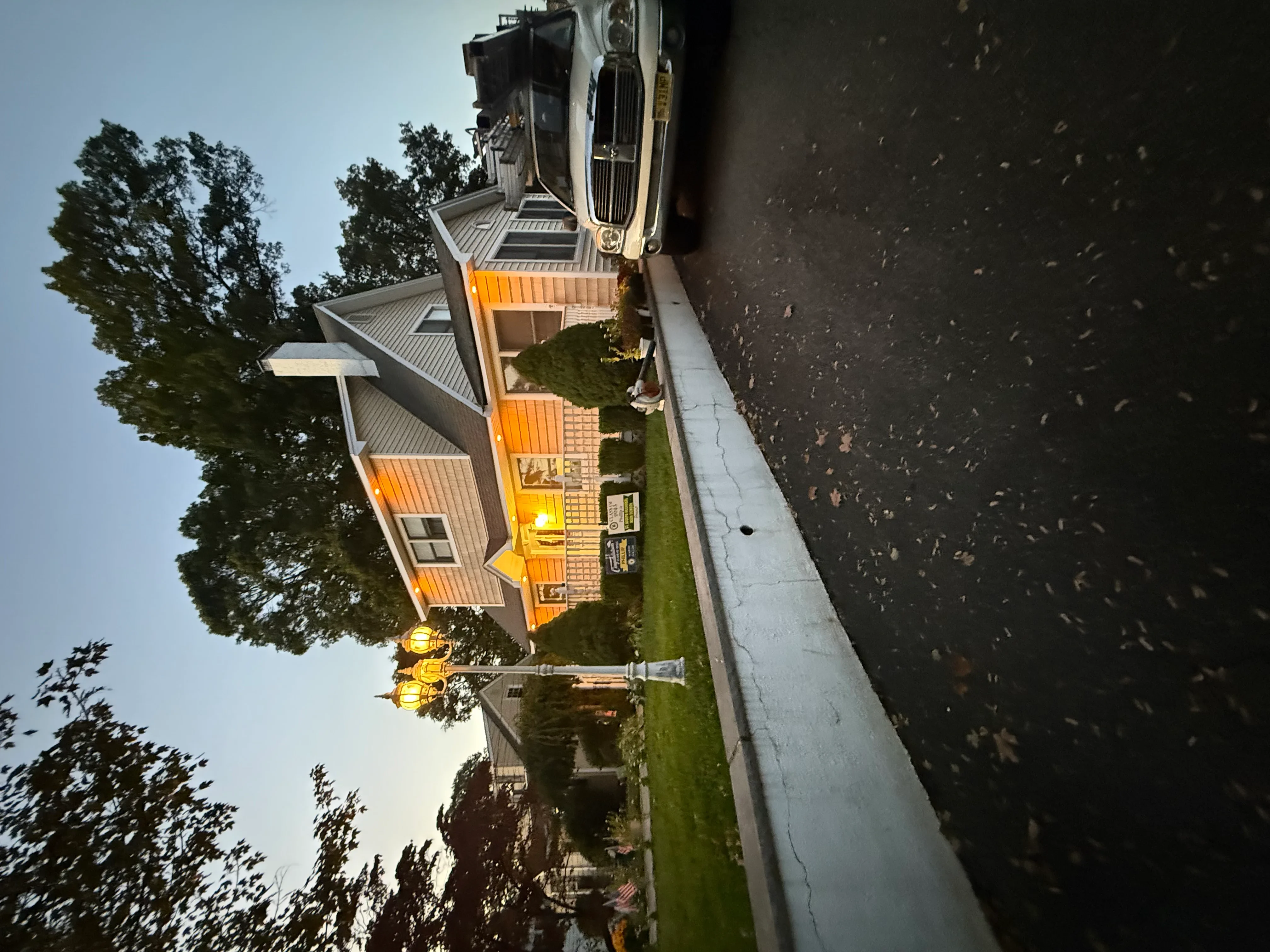 Standing seam metal roof with orange panels on brick residential home