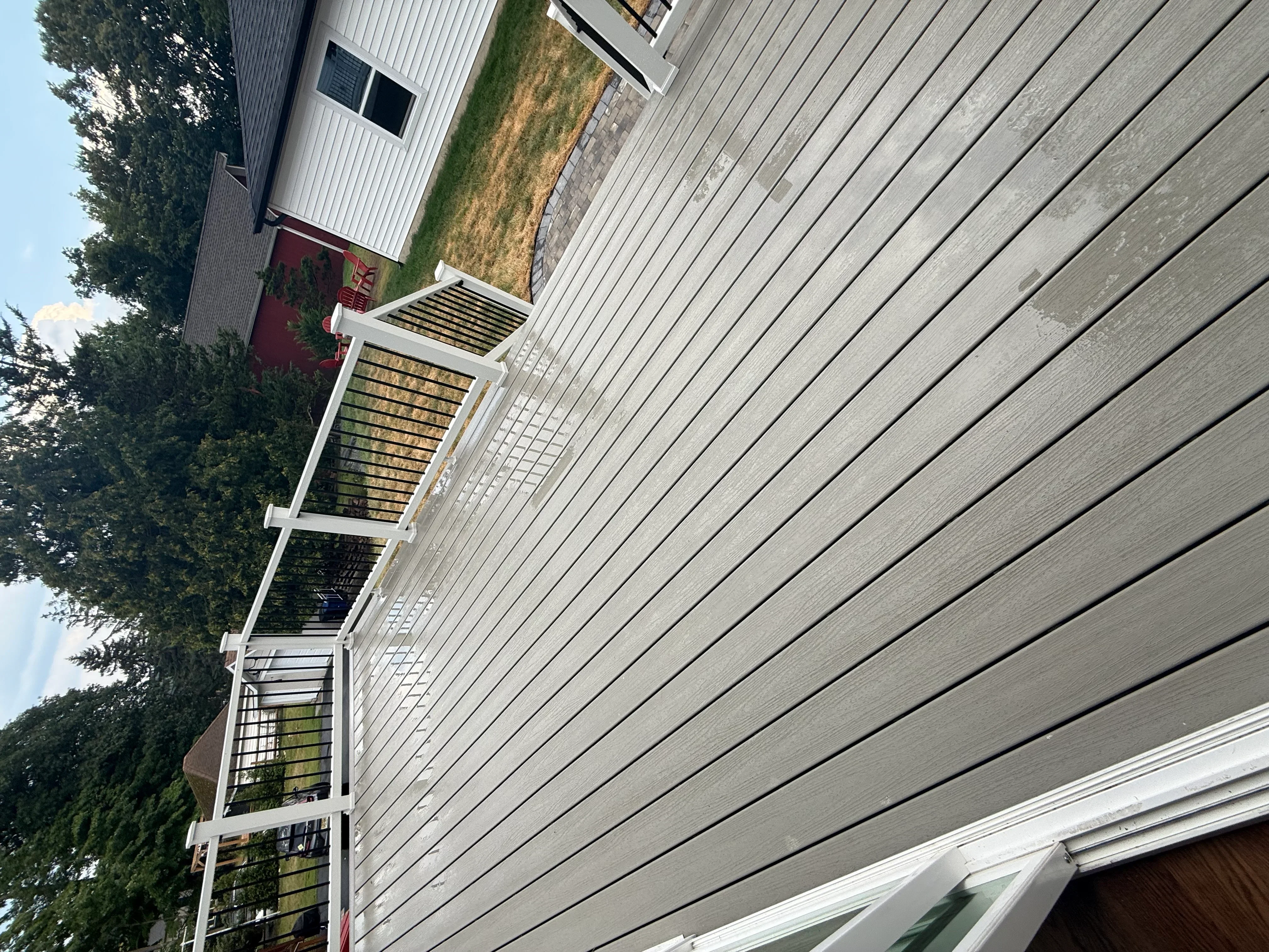 Gray fiber cement siding with white trim, soffit, and fascia on residential exterior